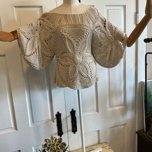Fun cable knit sweater with a large floral pattern